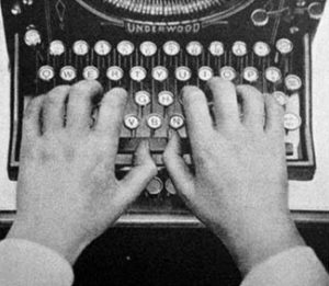 Hands on an Underwood Typewriter keyboard.