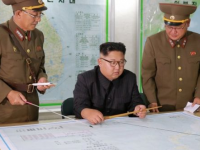 Kim Jong-un briefed by generals. (Image released by North Korean state news agency)