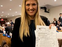 Beatrice Fihn, Executive Director of ICAN, with the signed UN Treaty on the Prohibition of Nuclear Weapons, 7 July 2017.
(Photo: Clare Conboy)