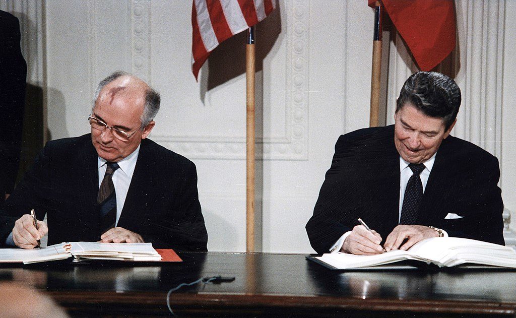Gorbachev and Reagan sign the INF Treaty in the East Wing of the White House, 1987. (Photo by White House Photographic Office, Public Domain, via Wikimedia Commons)