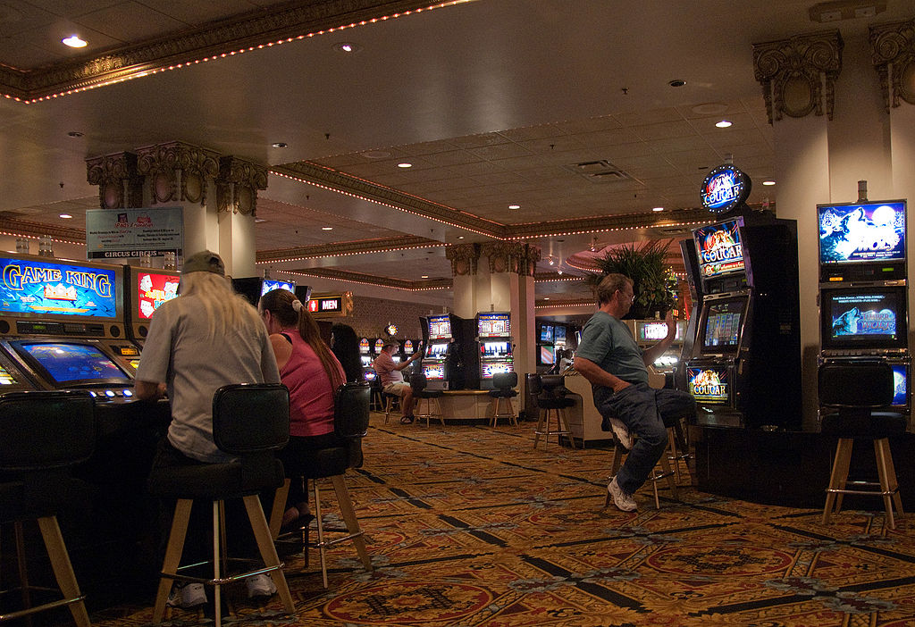 People playing slot machines.