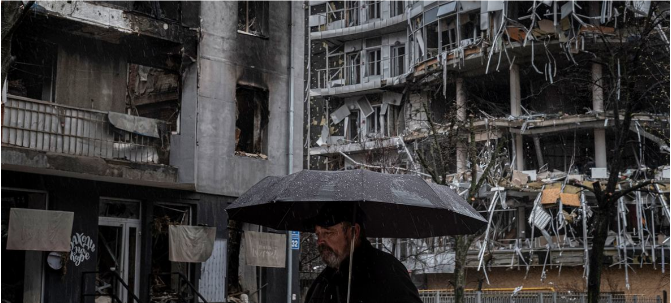 A man walks past destroyed apartment buildings in Kharkiv, Ukraine. 