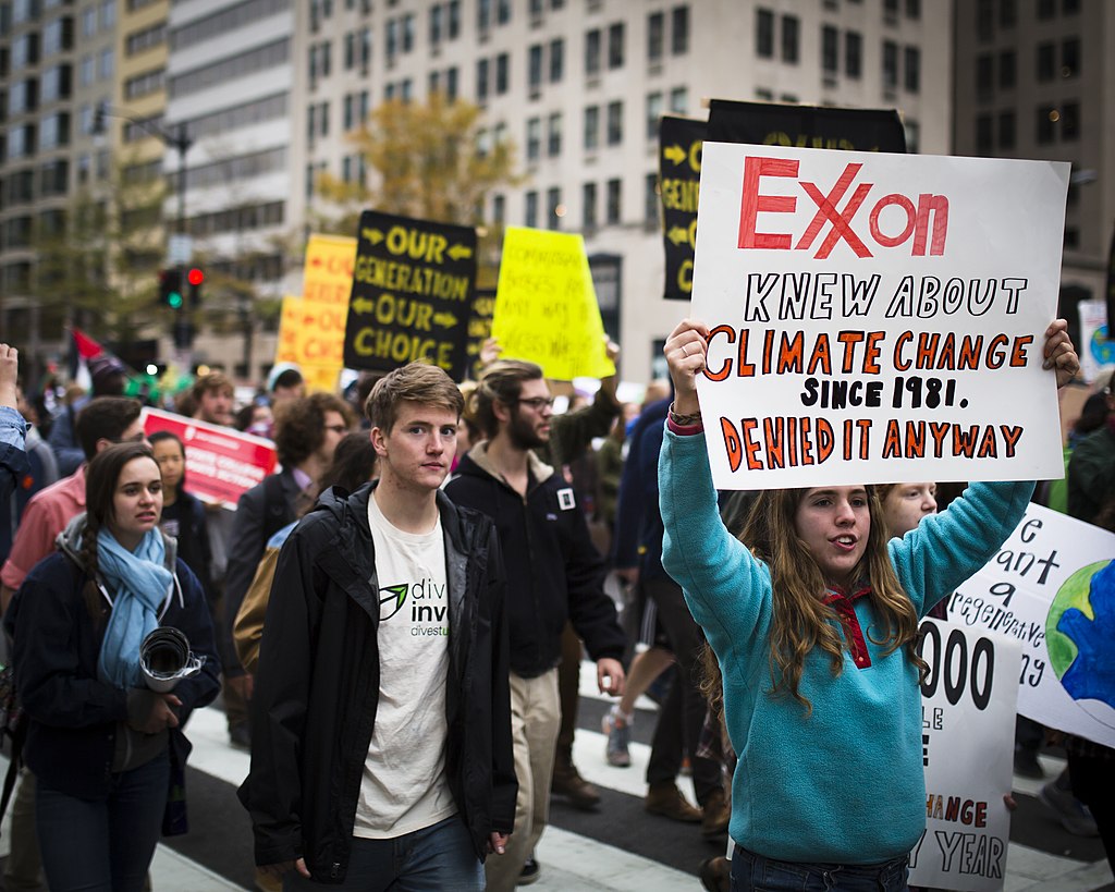 Climate protestors with "Exxon Knew" sign.