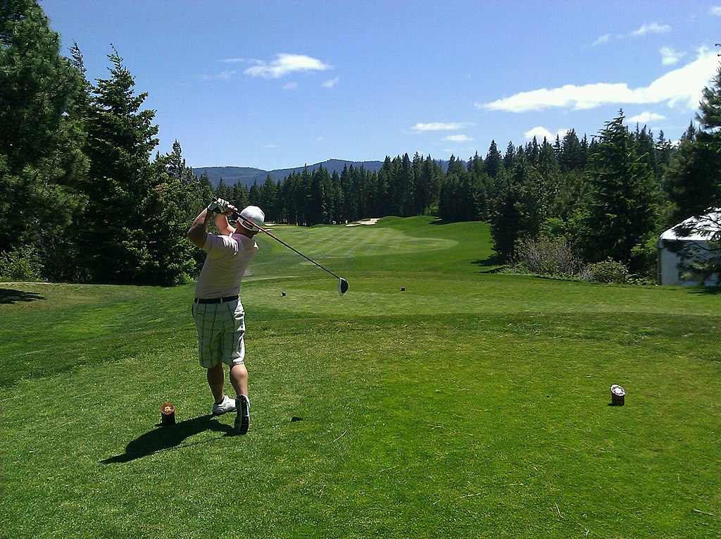 Golfer taking a tee shot.