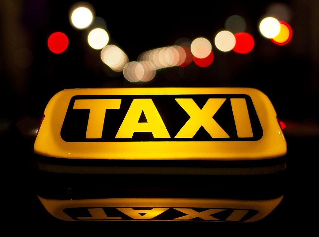 A photo of the sign on the top of a taxi.