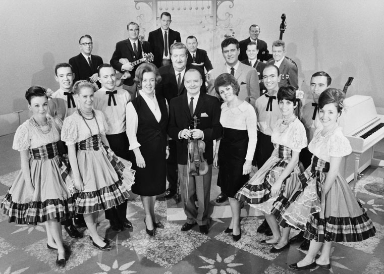A photo of a group of musicians and dancers.