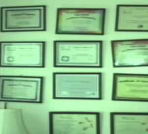 Photo of framed certificates on a wall.