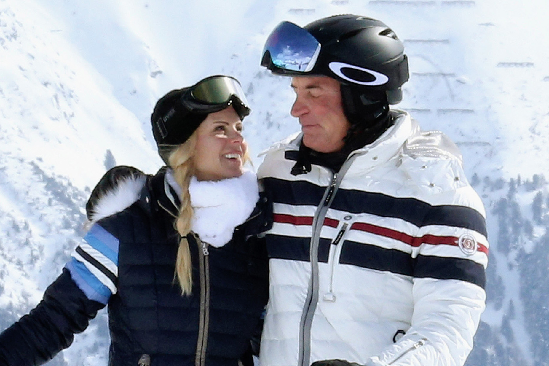 A man and a woman on a ski slope.